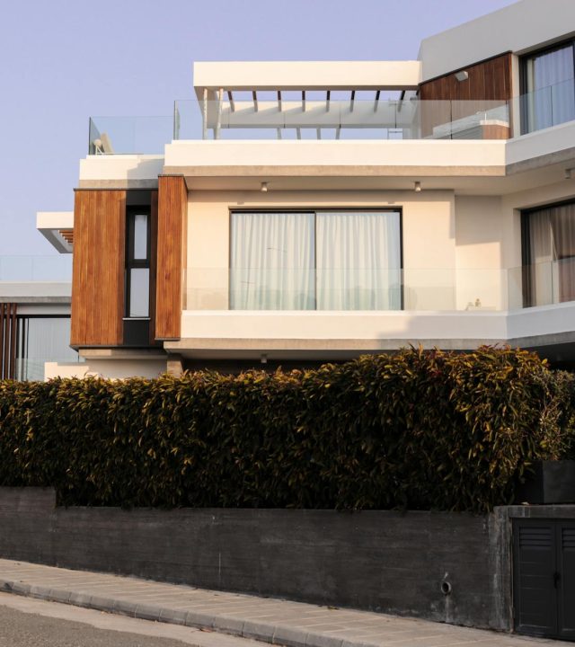 A contemporary luxury villa featuring minimalistic architecture and lush greenery.